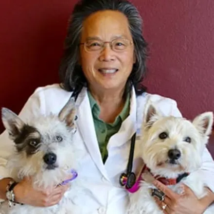Dr. Barbara Lee holding two dogs